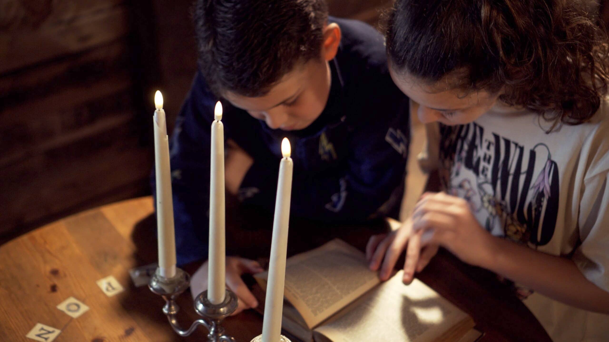 Two young children playing escape rooms in Powys