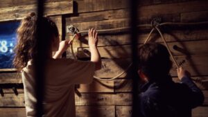Two young children playing escape rooms in Wales