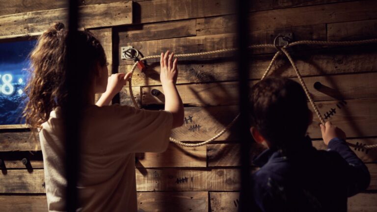 Two young children playing escape rooms in Wales